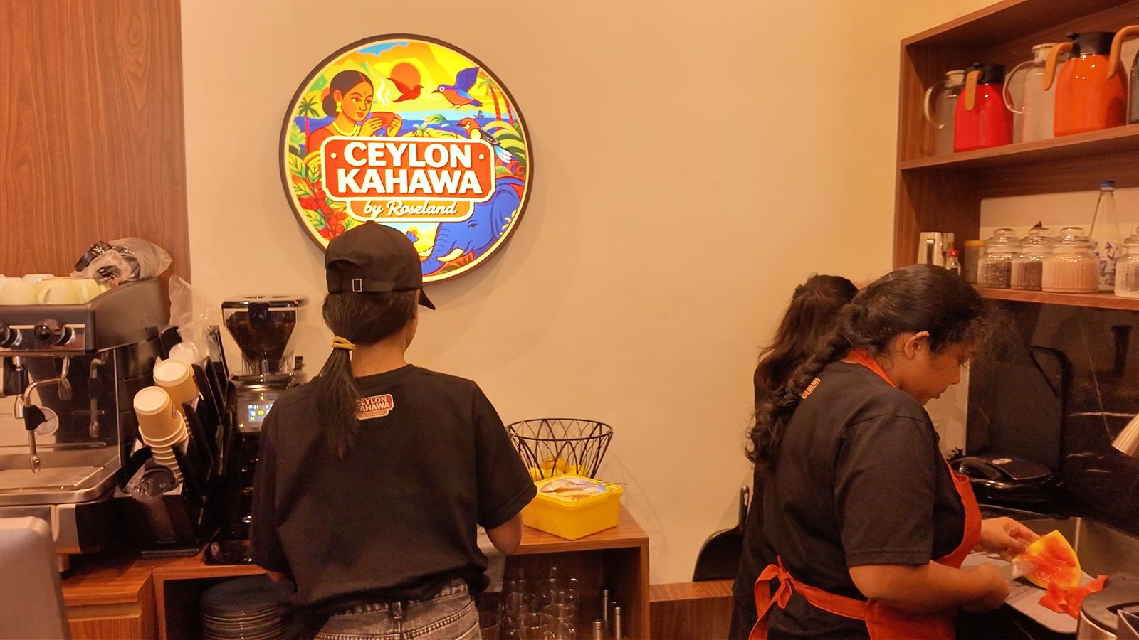 Ceylon Kahawa employees and logo at the counter